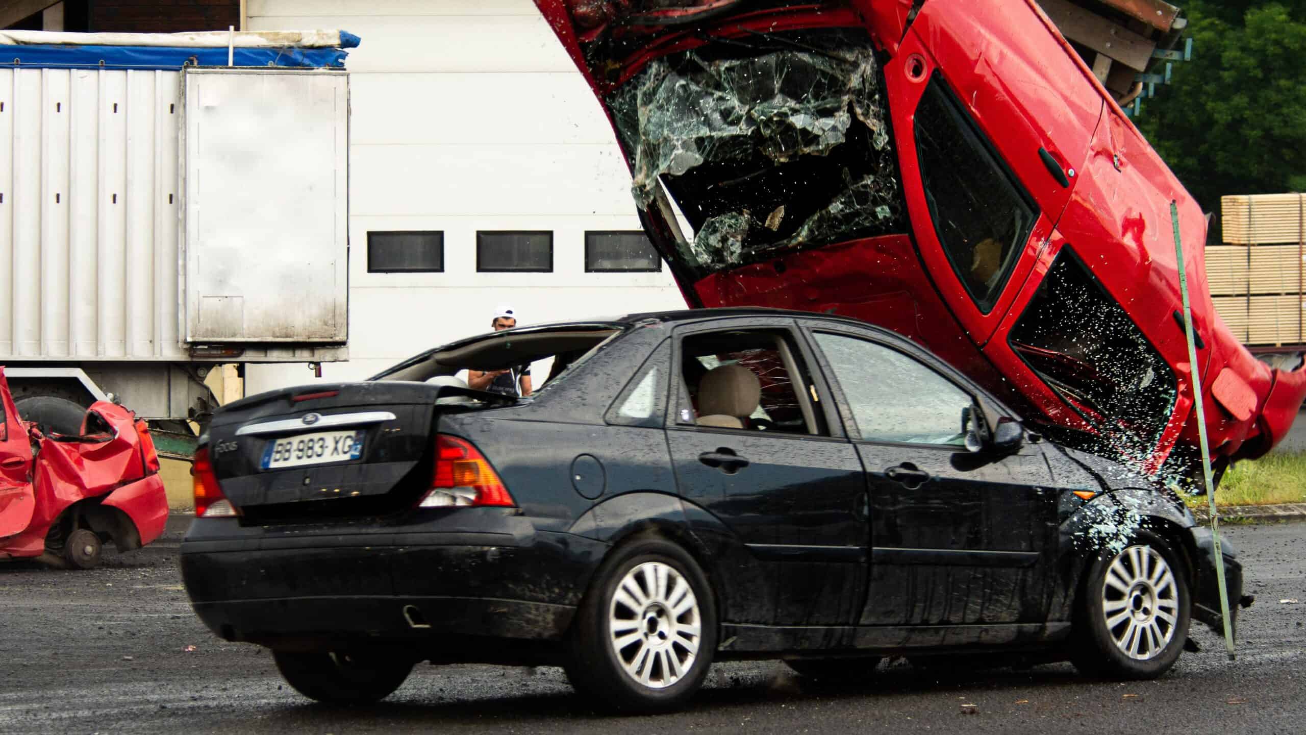 Two damaged cars at an intersection after a collision