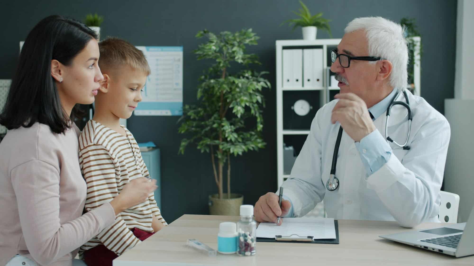 Mother and child talking with a doctor during a medical appointment